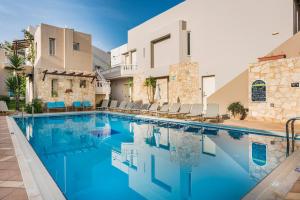 a large swimming pool in front of a house at Elotis Suites in Agia Marina Nea Kydonias