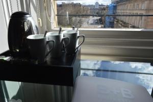 a coffee cup sitting on top of a counter next to a window at B+B Edinburgh in Edinburgh