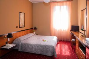 Postel nebo postele na pokoji v ubytování Hotel Milano Pool & Garden
