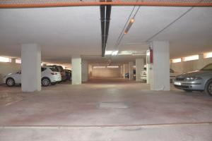 an empty parking garage with cars parked in it at H Pelayo Auto Check-In Rooms in Noja