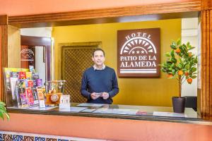 a woman standing in front of a counter in a kitchen at Patio de La Alameda in Seville