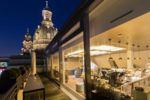 a restaurant with a clock tower in the background at Townhouse Dresden in Dresden
