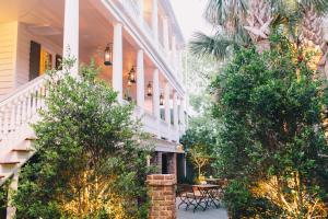 a house with a courtyard with tables and trees at Zero George Hotel in Charleston