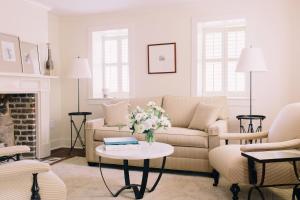 a living room with a couch and a table with flowers at Zero George Hotel in Charleston