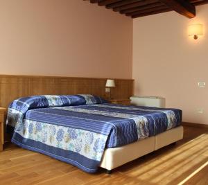 Postel nebo postele na pokoji v ubytování Agriturismo Le Giarine