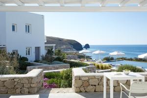 a patio with a view of the ocean and mountains at Milos Breeze Boutique Hotel in Pollonia