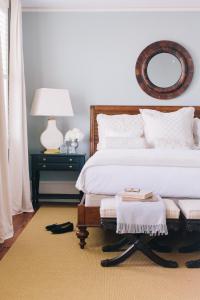 a bedroom with a bed and a table with a mirror at Zero George Hotel in Charleston