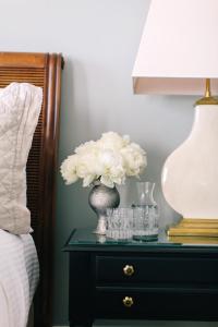 a table with a vase with white flowers on it at Zero George Hotel in Charleston