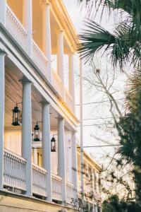 a large white building with columns and balconies at Zero George Hotel in Charleston