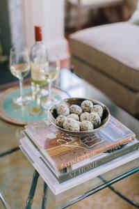 a table with a tray of muffins on top of books at Zero George Hotel in Charleston