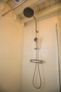 a shower with a shower head in a bathroom at Landelijk logeren bij De Witte Kip in 't Harde +25 photos