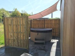 a backyard with a fence and a hot tub at Parkknott Retreat Luxury Lodge with Private Hot Tub in Askam in Furness +2 photos