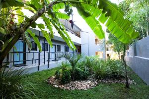 a courtyard of a building with trees and plants at Hillside Executive Accommodation in Windhoek