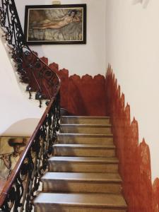 a staircase in a house with a painting on the wall at Hotel Celimar in Sitges