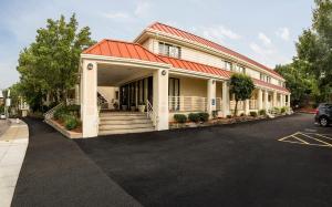 a building with a red roof and a parking lot at Hotel Boston in Boston