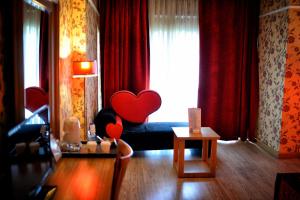 a living room with two hearts on a bed at Anemon Antakya Hotel in Hatay