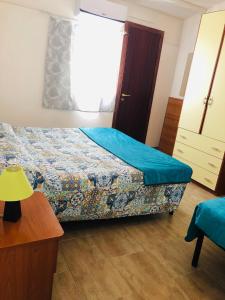 ポルトパーロにあるCamping Residence Capo Passeroのベッドルーム1室(青いシーツと窓付)