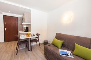 a living room with a couch and a small table at Bois des Coqs in Saint-Chaffrey