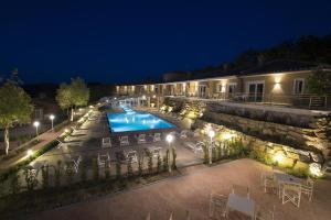 a resort with a swimming pool at night at Relais I Piastroni in Monteverdi Marittimo