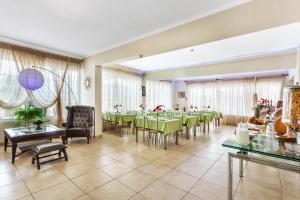 a dining room with a long table and chairs at Amfion Hotel in Olympic Beach