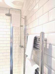 a bathroom with a shower with white subway tiles at Mode Hotel Lytham in Lytham St Annes