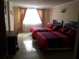 Postel nebo postele na pokoji v ubytování Hotel Astore Suites + 17 fotografií