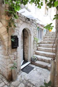 an entrance to a stone building with stairs at Phaedra Apartment in Trogir