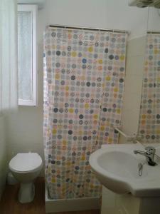 a bathroom with a toilet and a shower curtain at casita bonita in Vinaròs +18 photos