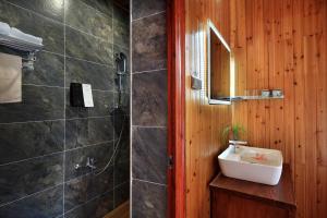 a bathroom with a sink and a shower at Baike Boutique Hotel in Longsheng