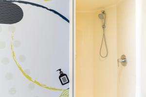 a bathroom with a shower with a shower head at ibis budget Paris Porte de Vincennes in Paris