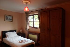 a bedroom with a bed and a window at HayLaneLodge in Solihull
