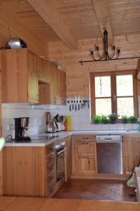 a kitchen with wooden cabinets and a stove at Marhütte in Ebene Reichenau