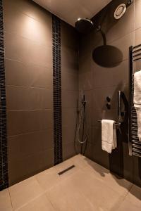 a bathroom with a shower stall and a sink at Rose And Crown Hotel in London