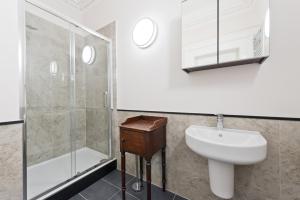a bathroom with a sink and a shower at Henrietta Suites City Centre in Dublin +128 photos