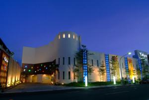 a large white building with lights on it at night at Takao Love Motel in Kaohsiung