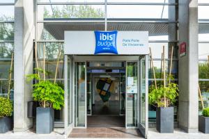 an office building with a sign on the door at ibis budget Paris Porte de Vincennes in Paris