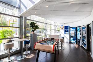 a game room with a foosball table and stools at ibis budget Paris Porte de Vincennes in Paris