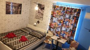 a room with a bed and a wall with comics at Penzion Hádlík in Velké Pavlovice