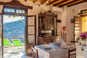 a kitchen with a table and a large window at Fimaira in Ermoupoli