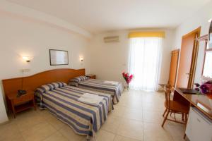 Voodi või voodid majutusasutuse Hotel Orchidea toas