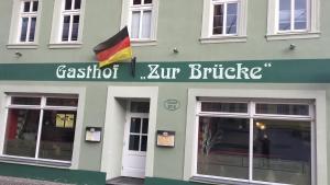 ein Gebäude mit einer Flagge auf der Vorderseite in der Unterkunft Gasthof " Zur Brücke" in Alsleben