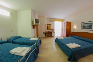 Voodi või voodid majutusasutuse Hotel Orchidea toas