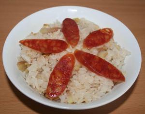 a white plate of rice and sausages and fruit at KHÁCH SẠN NGỌC LY 2 in Thanh Hóa