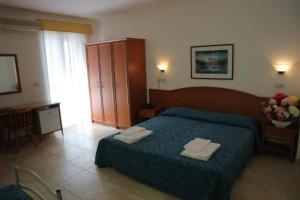 Voodi või voodid majutusasutuse Hotel Orchidea toas
