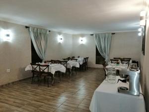 a restaurant with tables and chairs in a room at Kanyane Lodge in Jane Furse