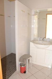 a bathroom with a sink and a stool at MARGARIDOU in Blesle