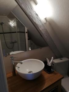 a bathroom with a white sink and a toilet at Appartement Henri II in Le Mans +9 photos