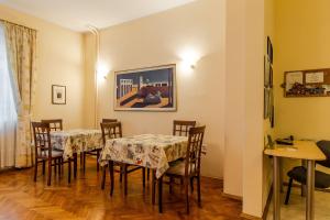 a dining room with two tables and chairs at Casa Ferrari Bed & Breakfast in Sofia