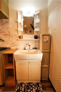 a bathroom with a sink and a mirror at Wayado Sapporo Ciao in Sapporo +203 photos