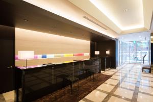 a lobby with a reception desk in a building at Super Hotel Premier Tokyo Station Yaesu-Chuoguchi in Tokyo